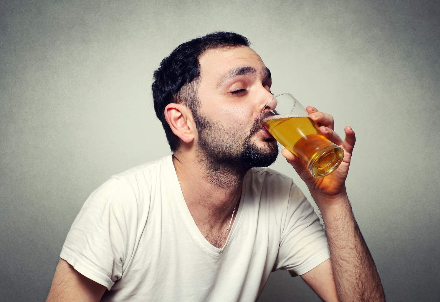 funny bearded man close up drinking beer